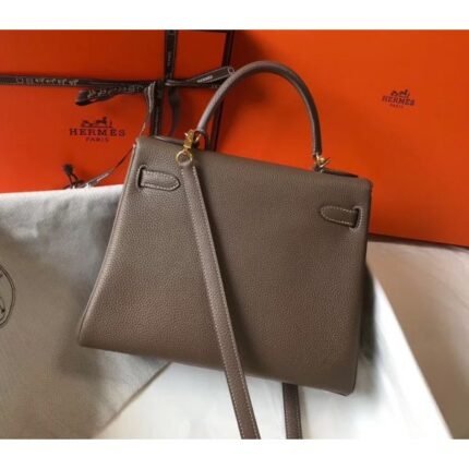 herm kelly 25cm retourne bag in taupe clemence leather
