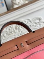 zip cabine 31 bag in punch pink canvas and bronze brown calfskin